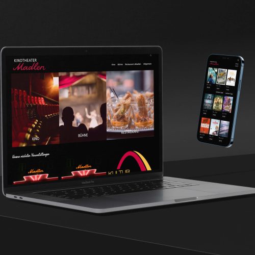 Ein MacBook und ein Smartphone auf denen die Website des Kinotheater Madlen geöffnet ist